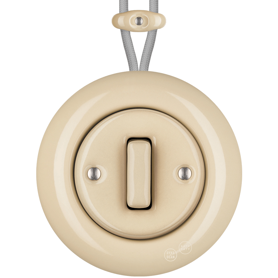 PORCELAIN KATY PATY COLONA ROUND SURFACE MOUNTED SLIM BUTTON SWITCH SAND - DYKE & DEAN